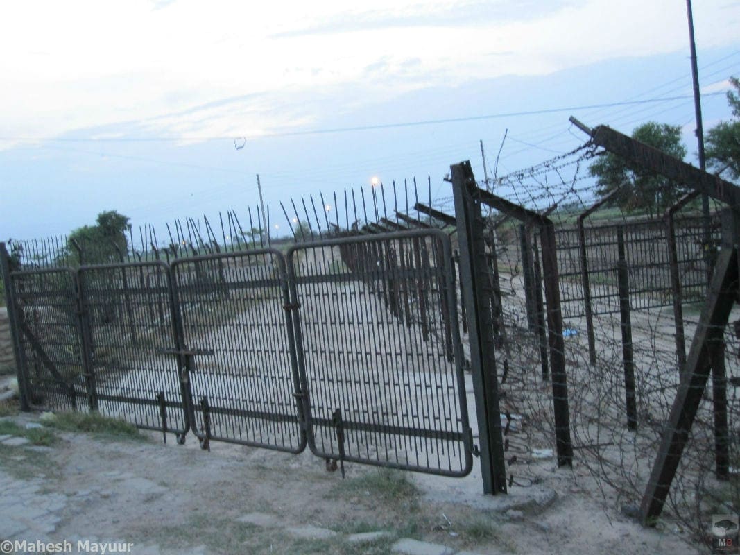 A fenced off road that goes in to Pakistan