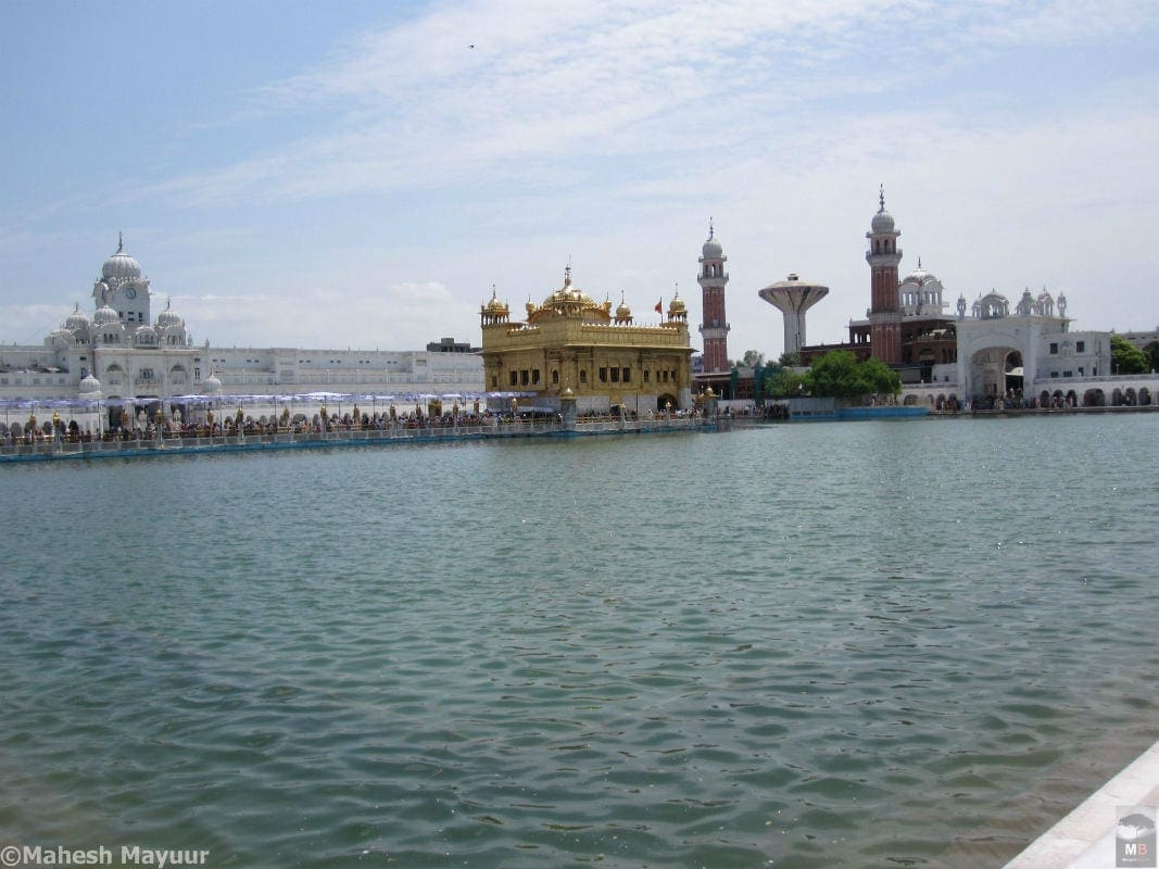 The Golden temple and its pool of waters sparkle in the sun