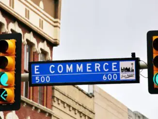 a traffic light with a street sign hanging from it's side online marketplaces