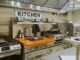 a smart kitchen with stainless steel appliances and a wooden counter
